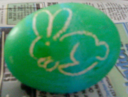 Bunny drawn in white crayon on an Easter egg